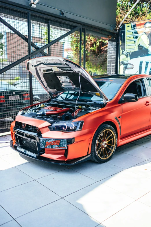 a car parked in a garage with its hood open, by An Gyeon, featured on reddit, full dress of lava showcase, intricate copper details, samurai vinyl wrap, ✨🕌🌙