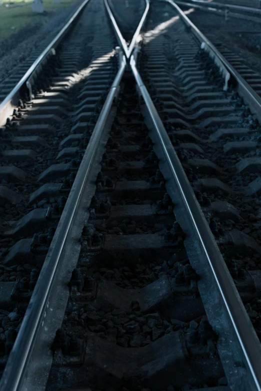 a couple of train tracks next to each other, precisionism, against dark background, getty images, multiple stories, pov