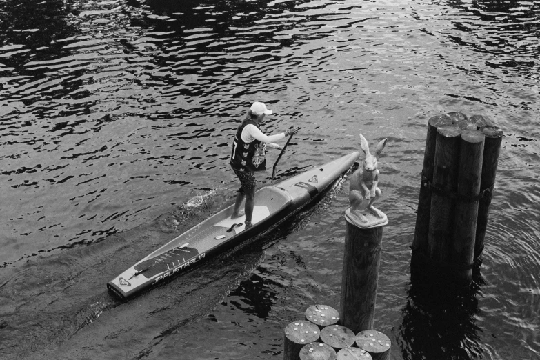 a man riding a paddle board on top of a river, a photo, inspired by Ruth Orkin, kodak tri-x 400, gondola, preparing to fight, very detailed »