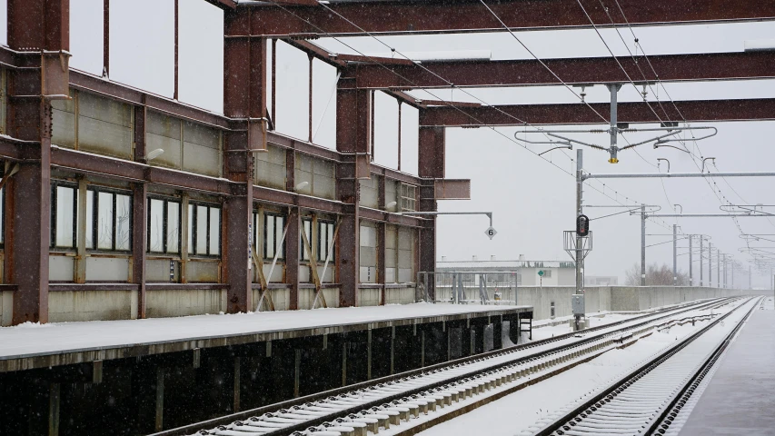 a train track and some snow on the ground