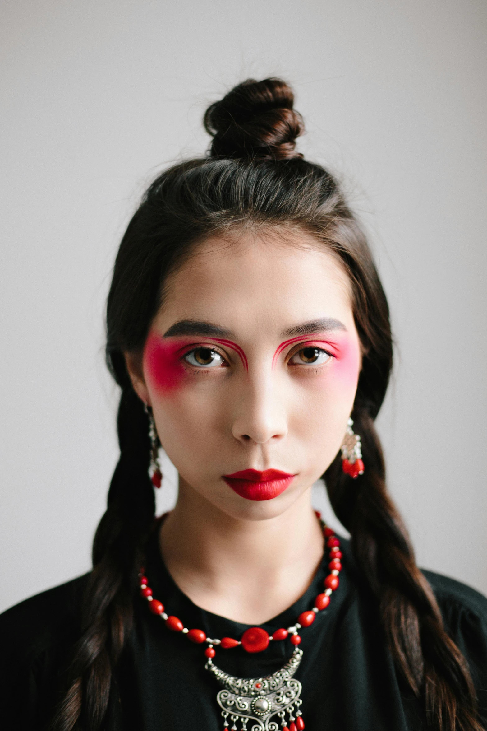 a woman with long hair wearing a necklace and earrings, inspired by Taro Yamamoto, trending on pexels, one eye red, portrait of a japanese teen, wearing eye shadow, non binary model