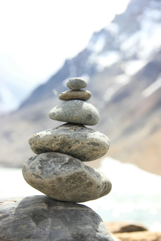 a pile of rocks stacked on top of each other, a statue, inspired by Andy Goldsworthy, unsplash, himalayas, lake view, ((rocks)), glacier