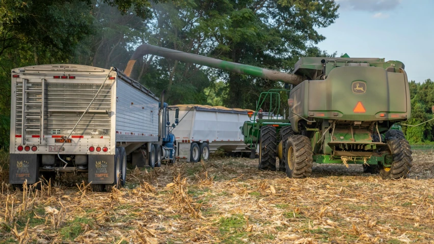 a tractor and a trailer in a field, by Chris Rahn, pexels, corn, organic biomass, 3 2 x 3 2, ultrawide image