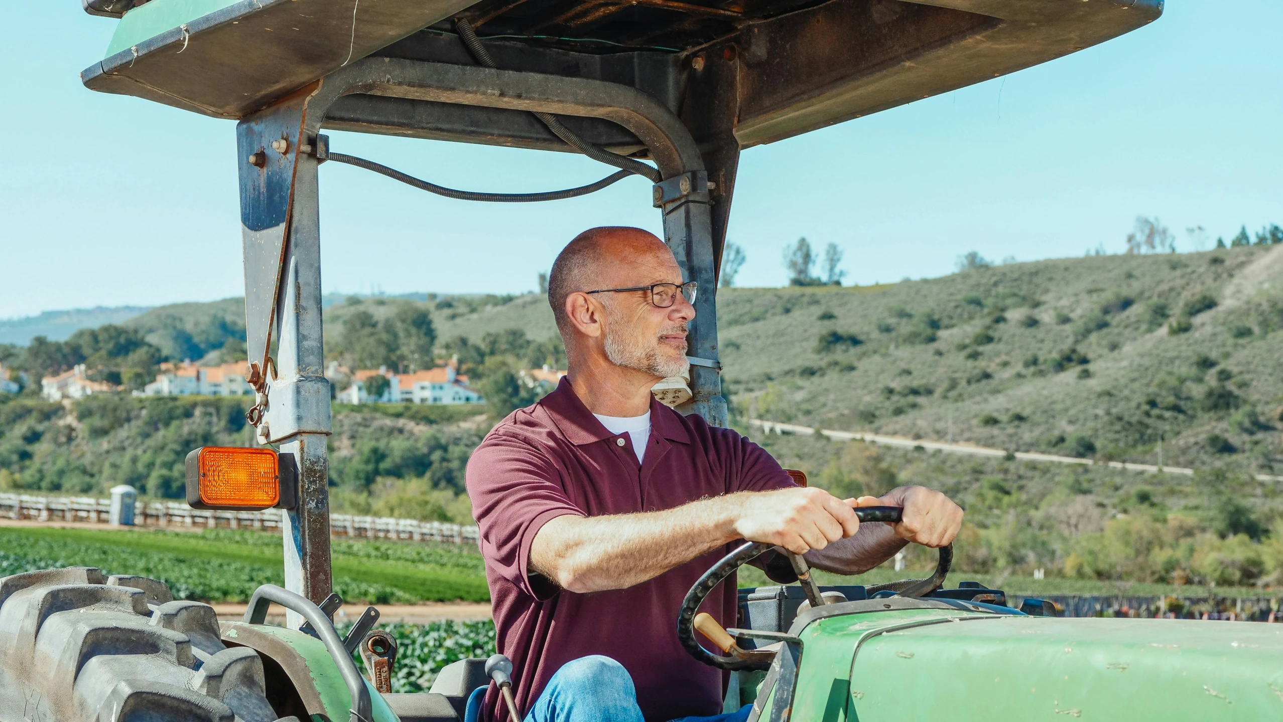 a man driving a tractor in a field, a portrait, by William Berra, pexels contest winner, renaissance, wine, bay area, avatar image, profile picture