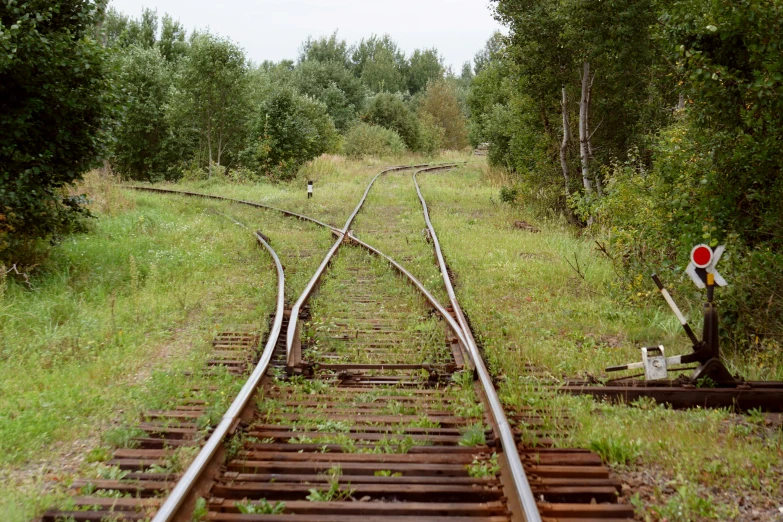 a red stop sign sitting on the side of a train track, an album cover, by Grytė Pintukaitė, russian landscape, 1999 photograph, ((rust)), signed