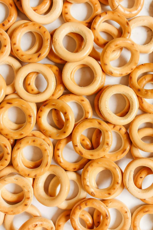 a pile of donuts sitting on top of a table, cheerios, orbital rings, made of swiss cheese wheels, organics