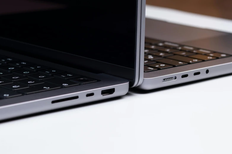 two laptops sitting side by side on a table, unsplash, ultra detailed close up, usb ports, no - text no - logo, solid gray