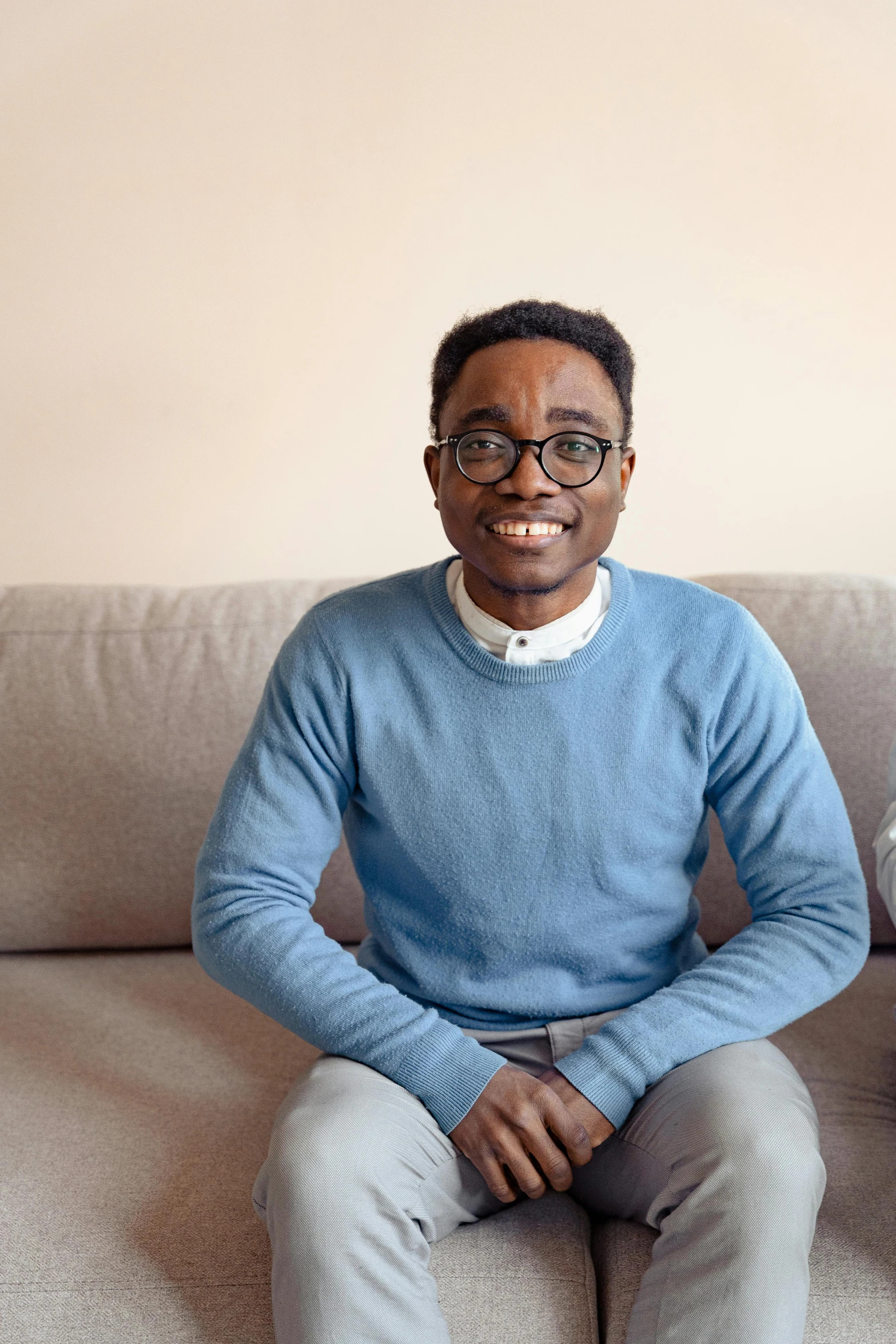 a man and a woman sitting on a couch, pexels contest winner, hurufiyya, wearing a light blue shirt, he is at college, osborne macharia, cute slightly nerdy smile