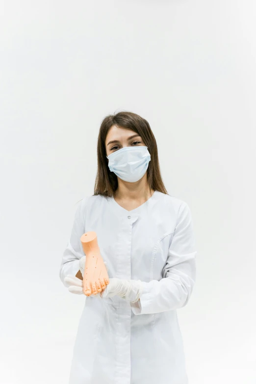 a woman wearing a face mask and gloves, by Adam Marczyński, white lab coat, prosthetic arm, clean white lab background, multiple stories