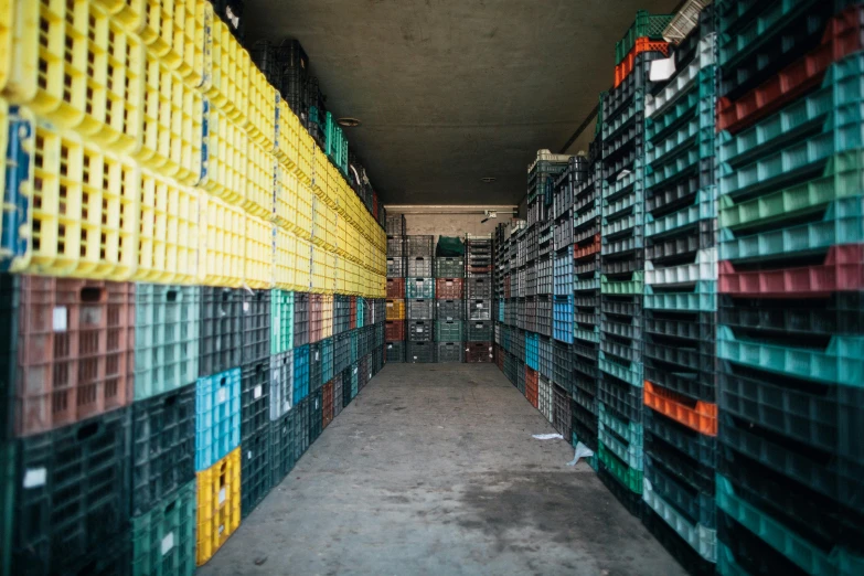 a long row of crates in a warehouse, by Daniel Lieske, plasticien, beer bottles, thumbnail, multicoloured, inside a shed