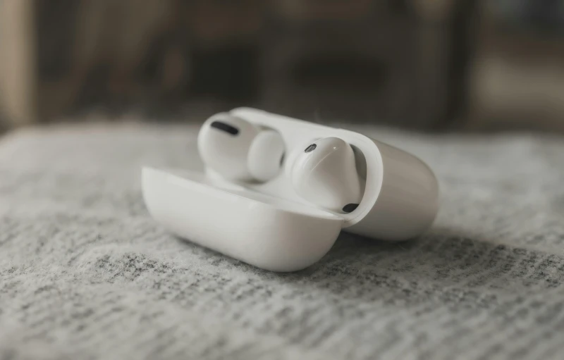 a pair of airpods sitting on top of a bed, a black and white photo, trending on pexels, on a white table, porcelain, aircraft, thin button nose