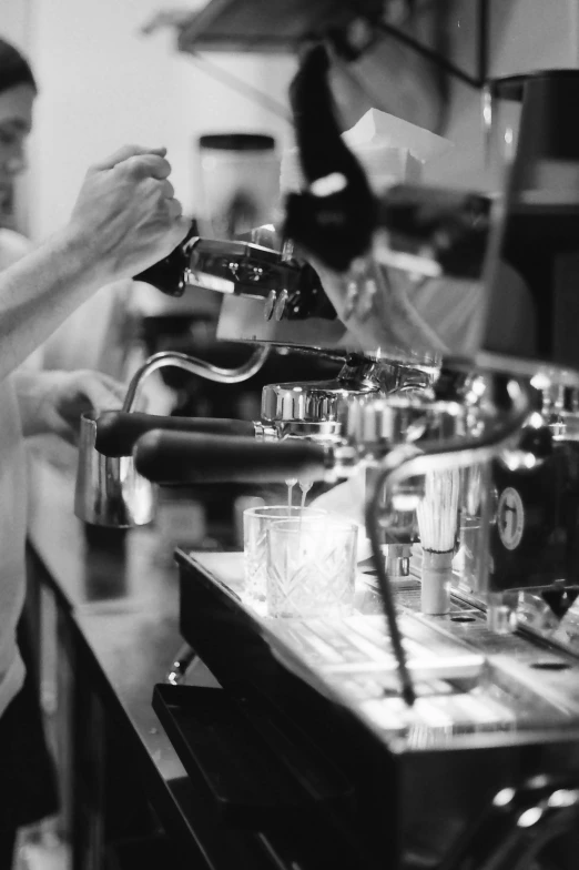 a black and white po of someone putting soing in a cup