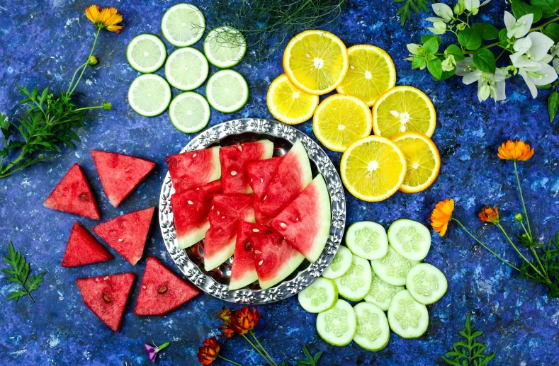 a plate filled with slices of watermelon and slices of cucumber, a still life, by Julia Pishtar, pexels, hurufiyya, made of flowers and fruit, green blue red colors, silver, bright neon color palette