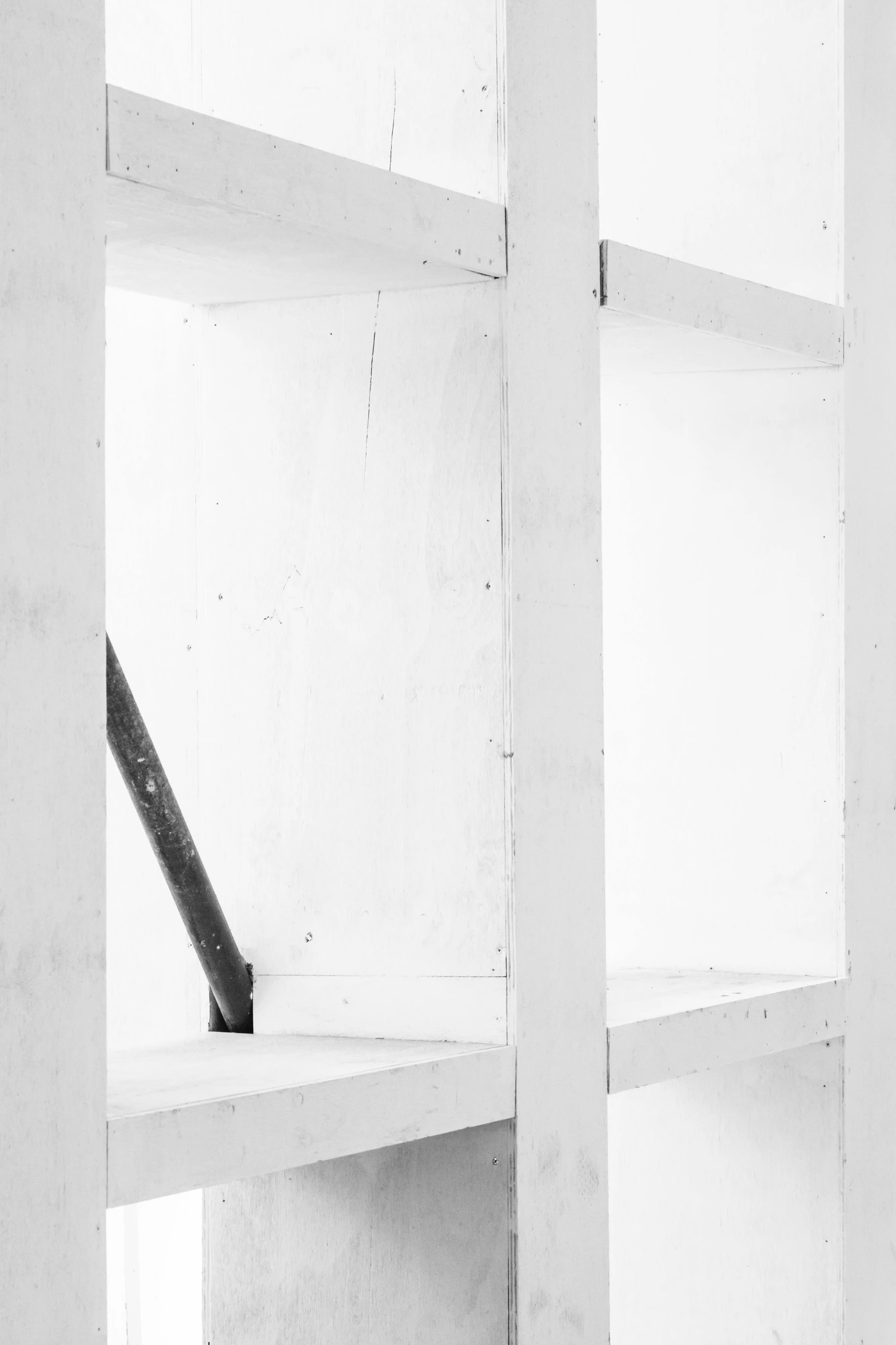 a black and white photo of a bookshelf, a black and white photo, inspired by Donald Judd, unsplash, ffffound, white mechanical details, unfinished, color photograph