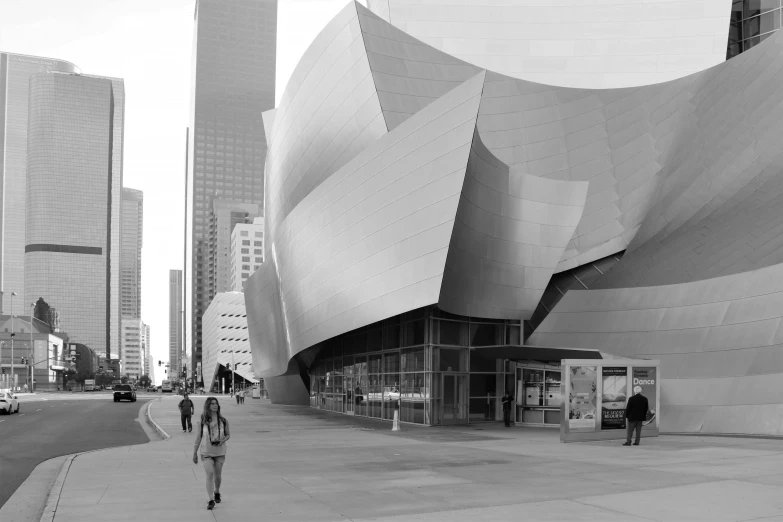 a black and white photo of people walking in front of a building, inspired by david rubín, concert hall, !dream los angeles, 4k greyscale hd photography, frank gehry architecture