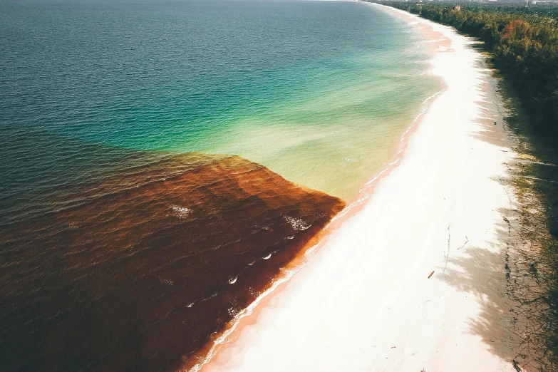 a large body of water next to a sandy beach, by Kristin Nelson, unsplash contest winner, hurufiyya, split dye, gulf, joel sternfeld, made of oil and water