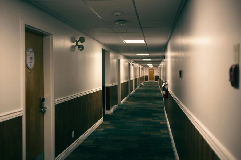 a long hallway with two lights and a door