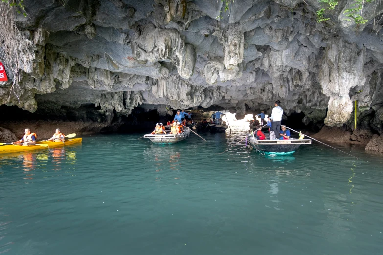 a group of people on small boats in a body of water, deep cave, phong shaded, calm weather, top down photo