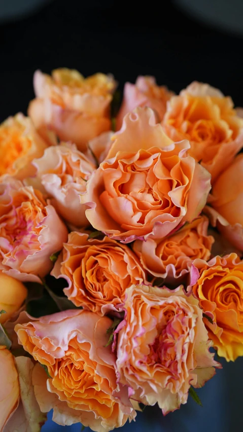 a bouquet of roses sitting on a blue vase