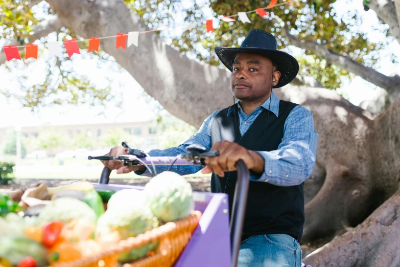 a man with a hat rides a bicycle