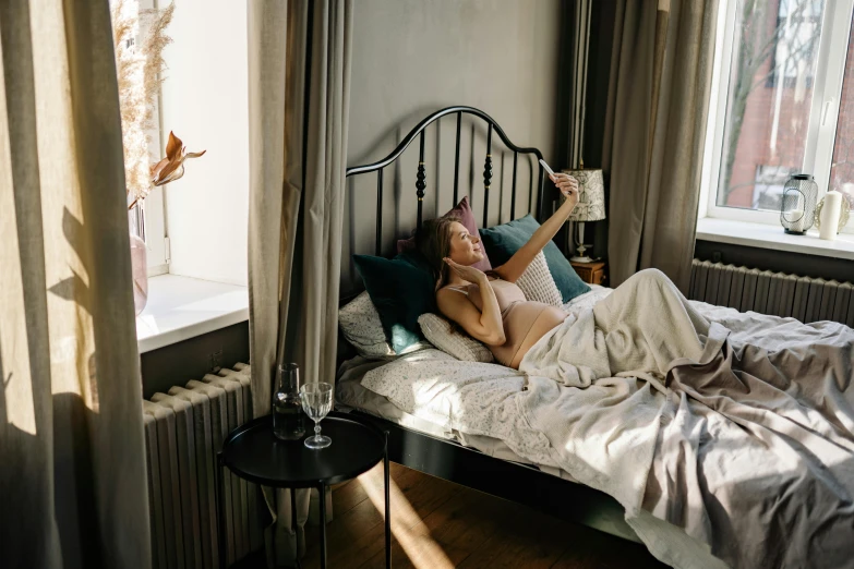 woman relaxing in bed at her home with bird and plant decoration