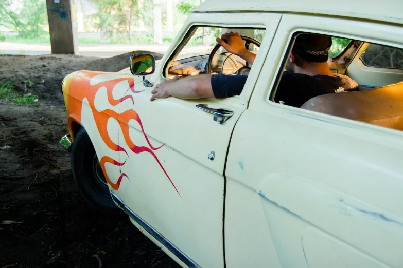 a man sitting in the driver's seat of a car, an album cover, by Tom Bonson, graffiti, firey, kombi, more scars and fire, profile image