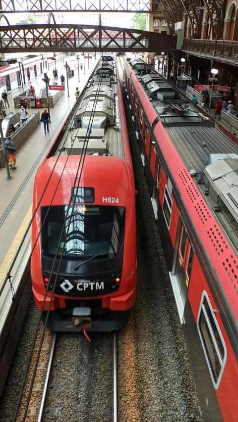 a couple of trains that are next to each other, by Almada Negreiros, shutterstock, in red and black, photograph credit: ap, a high angle shot, square