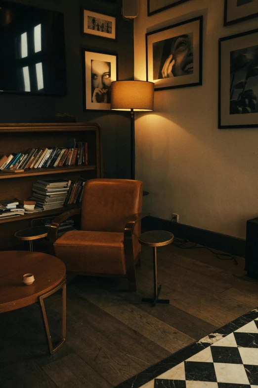 a dimly lit living room with large framed pictures