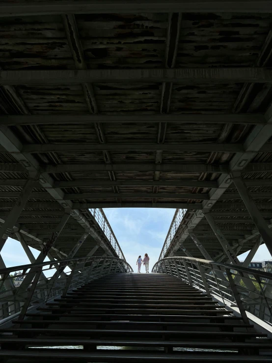 a man is standing at the top of a bridge