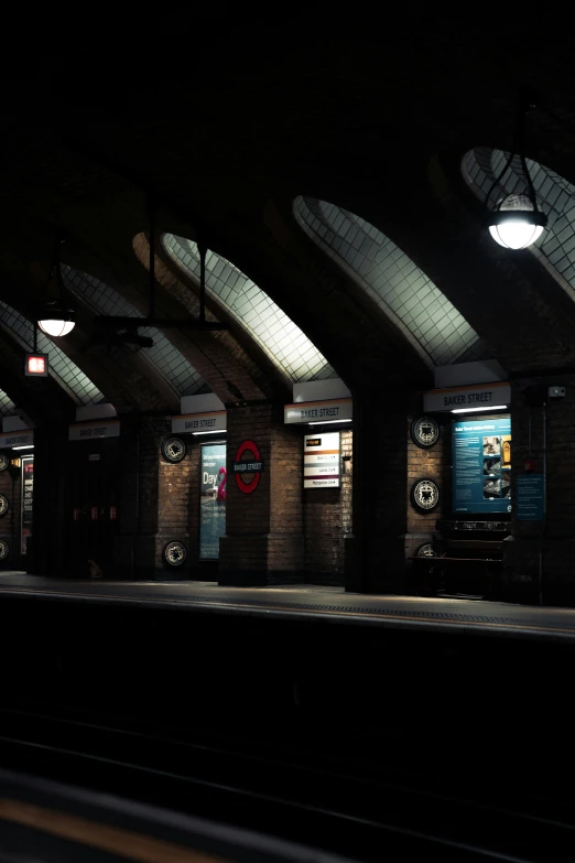 there are several lights on the platforms of this subway station