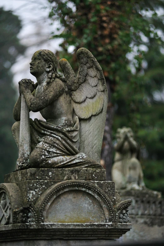 a statue of an angel sitting on top of a grave, lush surroundings, gothic influence, closeup of arms, facing away