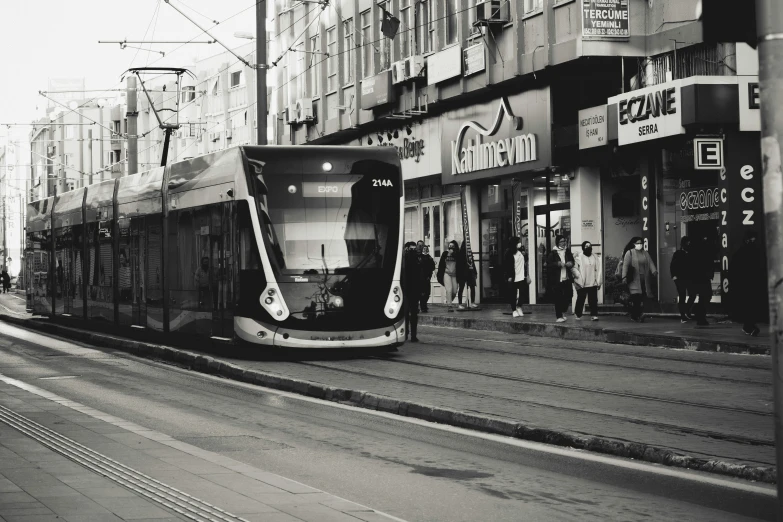 a tram is on the street and people are looking at it