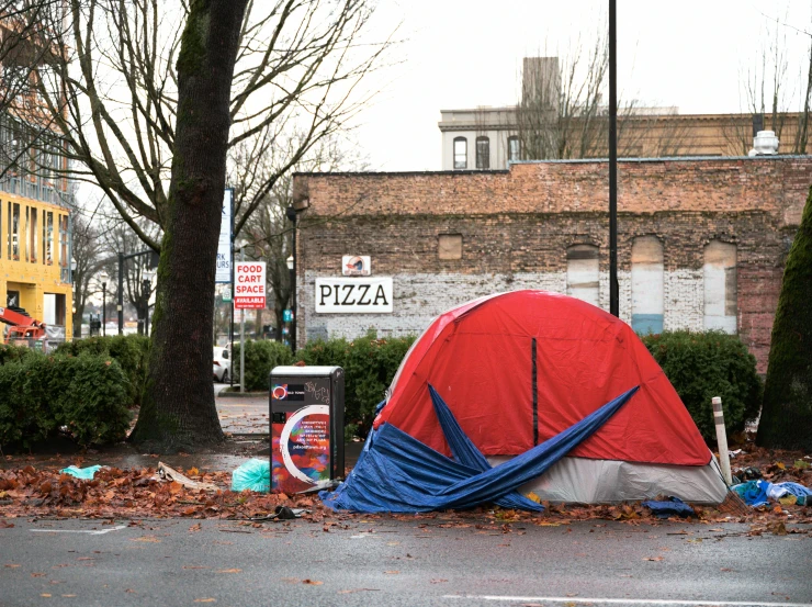 a red and blue tent sitting on the side of a road, a photo, arte povera, pizza, seattle completely wasted away, trending on dezeen, getty images