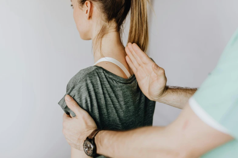 a person who has their hands on the shoulder of another woman