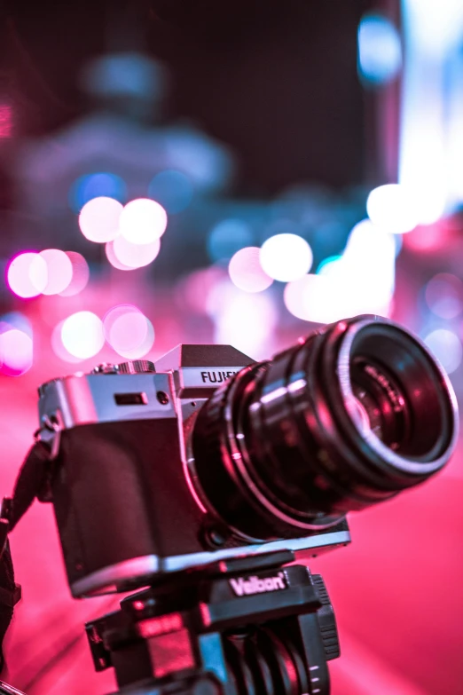 a close up of a camera on a tripod, by Nick Fudge, unsplash contest winner, city lights bokeh, anime style mixed with fujifilm, expo-sure 1/800 sec at f/8, soft light 4 k in pink