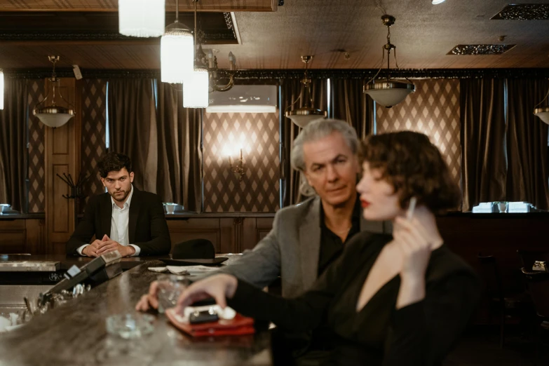 two people are seated in a fancy restaurant bar