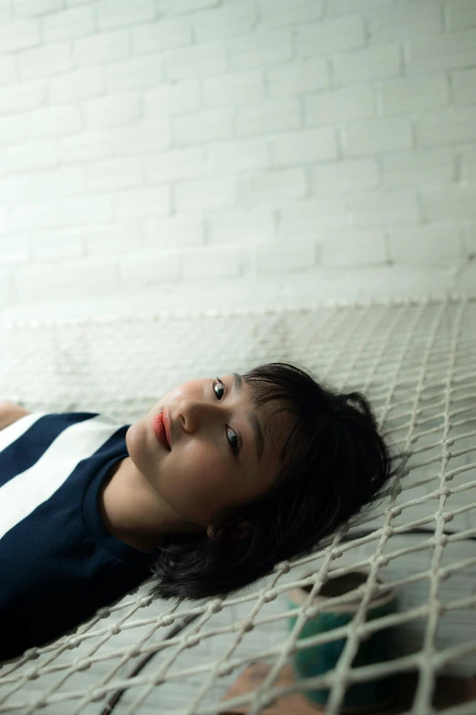 a woman laying in a hammock in a room, inspired by Fei Danxu, unsplash, happening, portrait of a japanese teen, bored expression, ignant, portrait androgynous girl