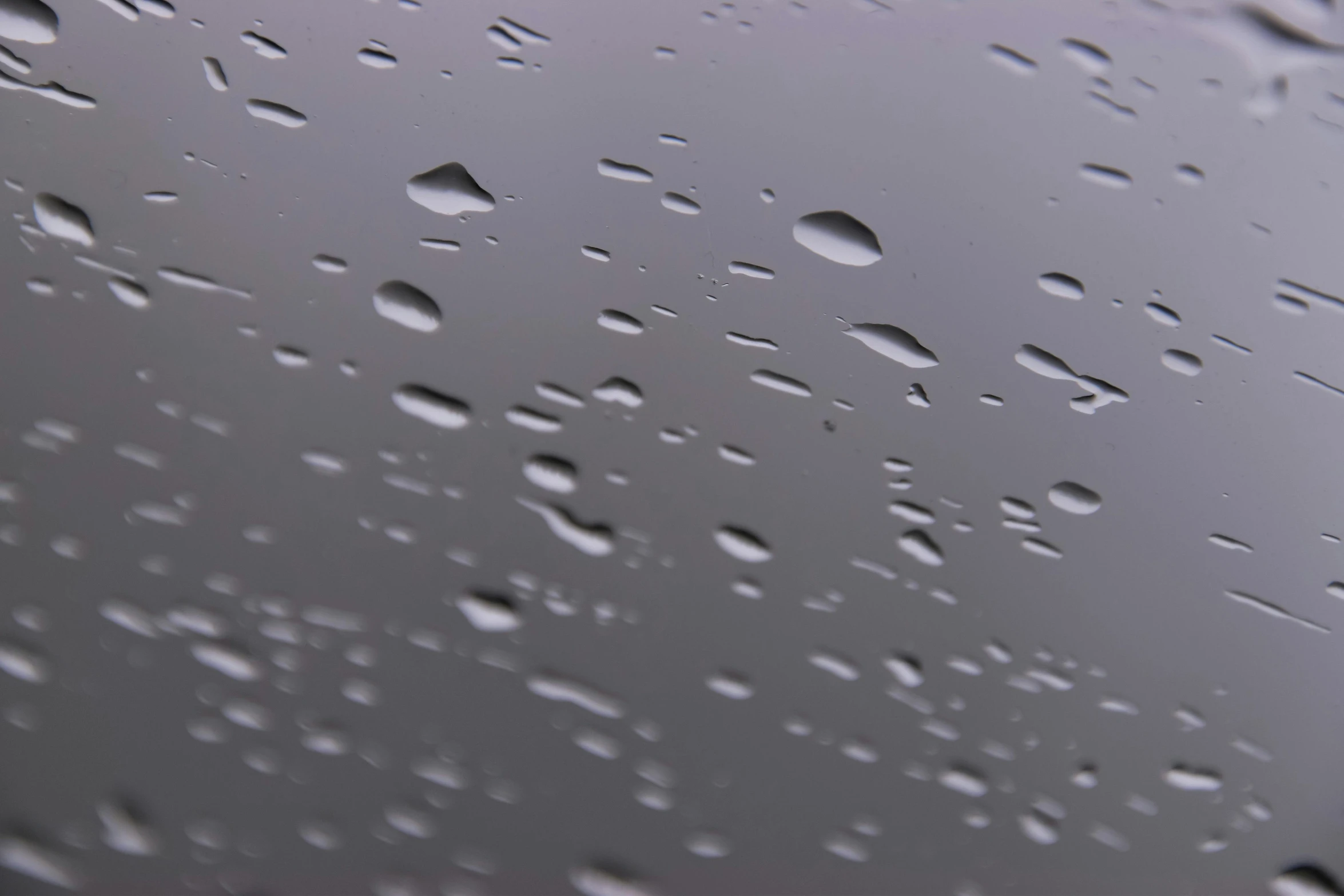 a close up of water droplets on a window, inspired by Vija Celmins, pexels, photorealism, 3 d octane render 8 k, gray sky, pbr material, low-angle