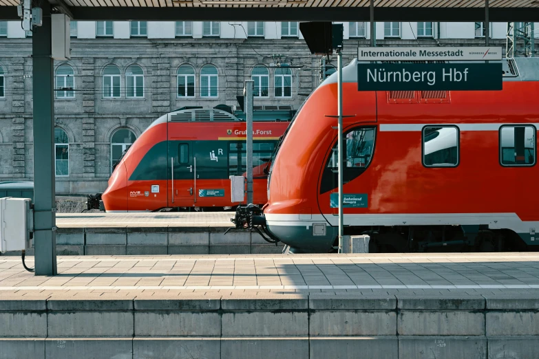 two trains parked next to each other at a train station, by Kristian Zahrtmann, pexels contest winner, square, grey orange, nuremberg, bright red