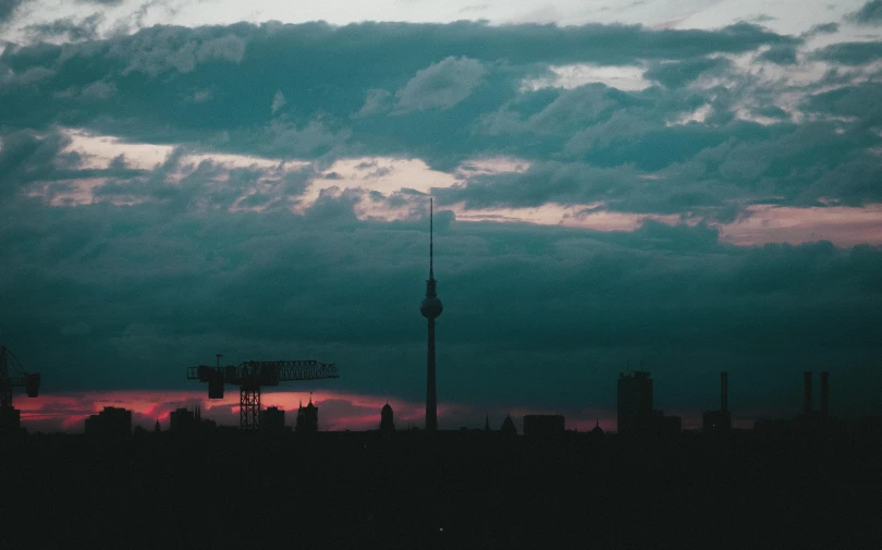 the sun shines on some clouds in a dark sky