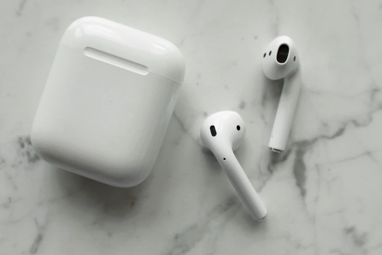 a pair of airpods sitting on top of a marble counter, by Carey Morris, pexels, square, white, aircraft, apples