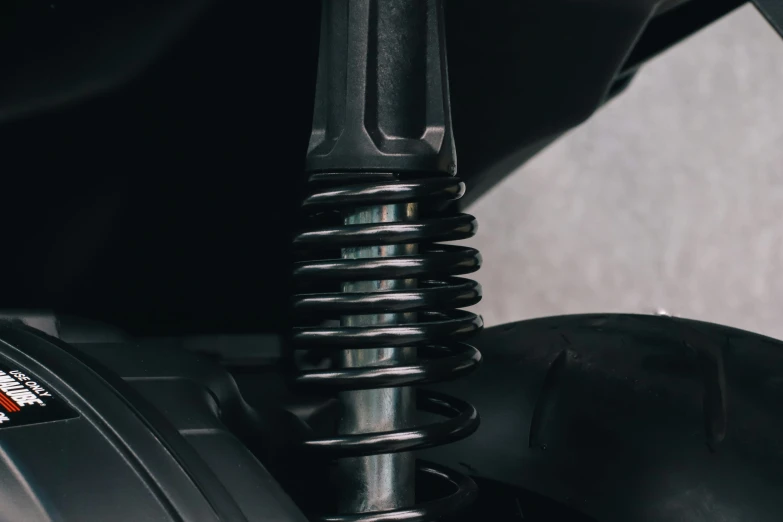 a close up of a motorcycle's front suspension, unsplash, process art, black glossy xenomorph, stacked image, sitting down casually, detailed product image