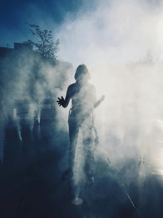 a person standing in front of a fire hydrant, an album cover, by Christen Dalsgaard, pexels contest winner, happening, :6 smoke grenades, shadows, concert, she is approaching heaven