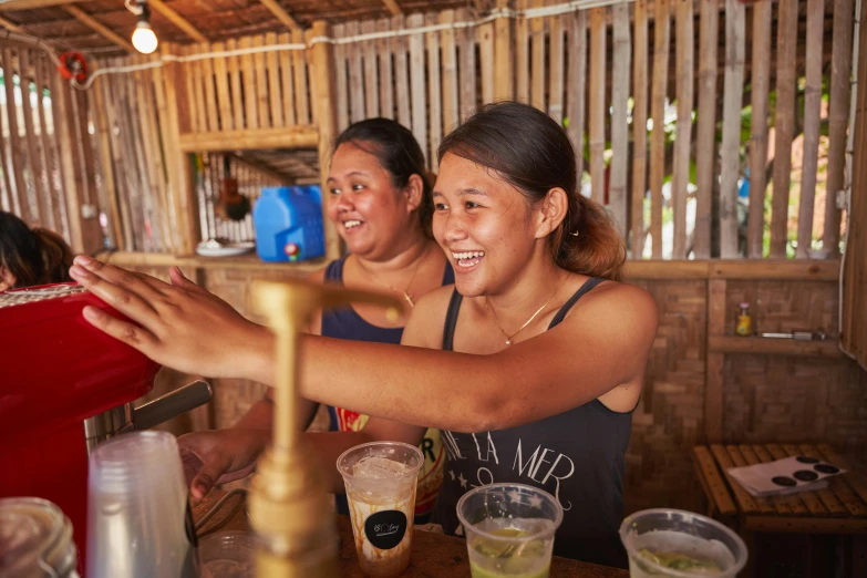 two women with one hand on the counter at the bar