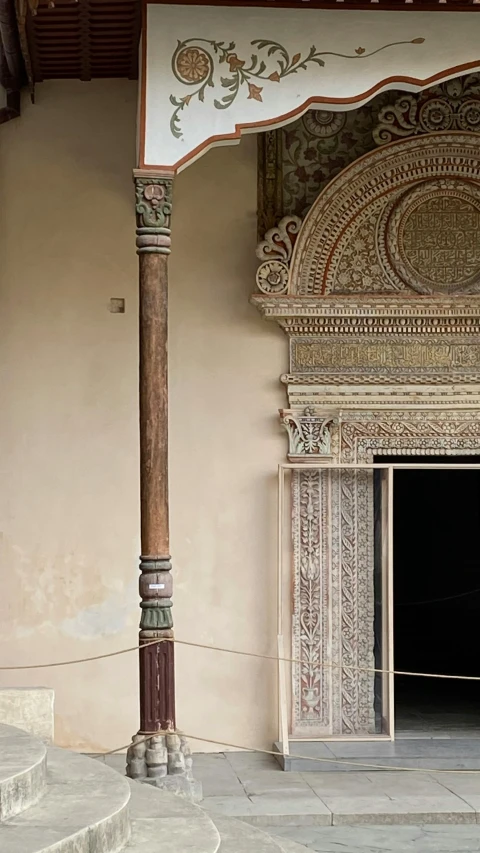 a man standing in front of a doorway in a building, a mosaic, inspired by Albert Joseph Moore, arabesque, ivory carved mantle, 155 cm tall, crystal column, viridian and venetian red