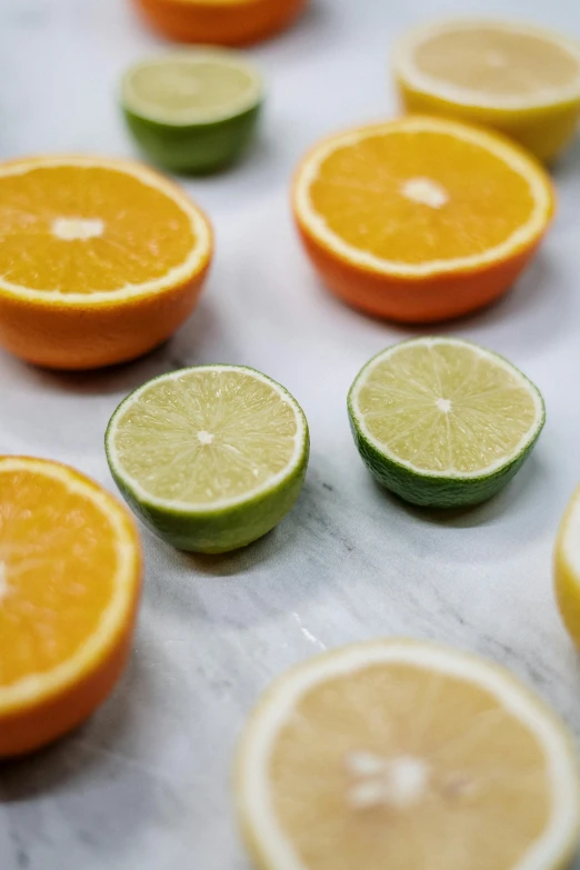 a table topped with slices of oranges and limes, subtle color variations, slightly smirking, mid - shot, smooth marble surfaces