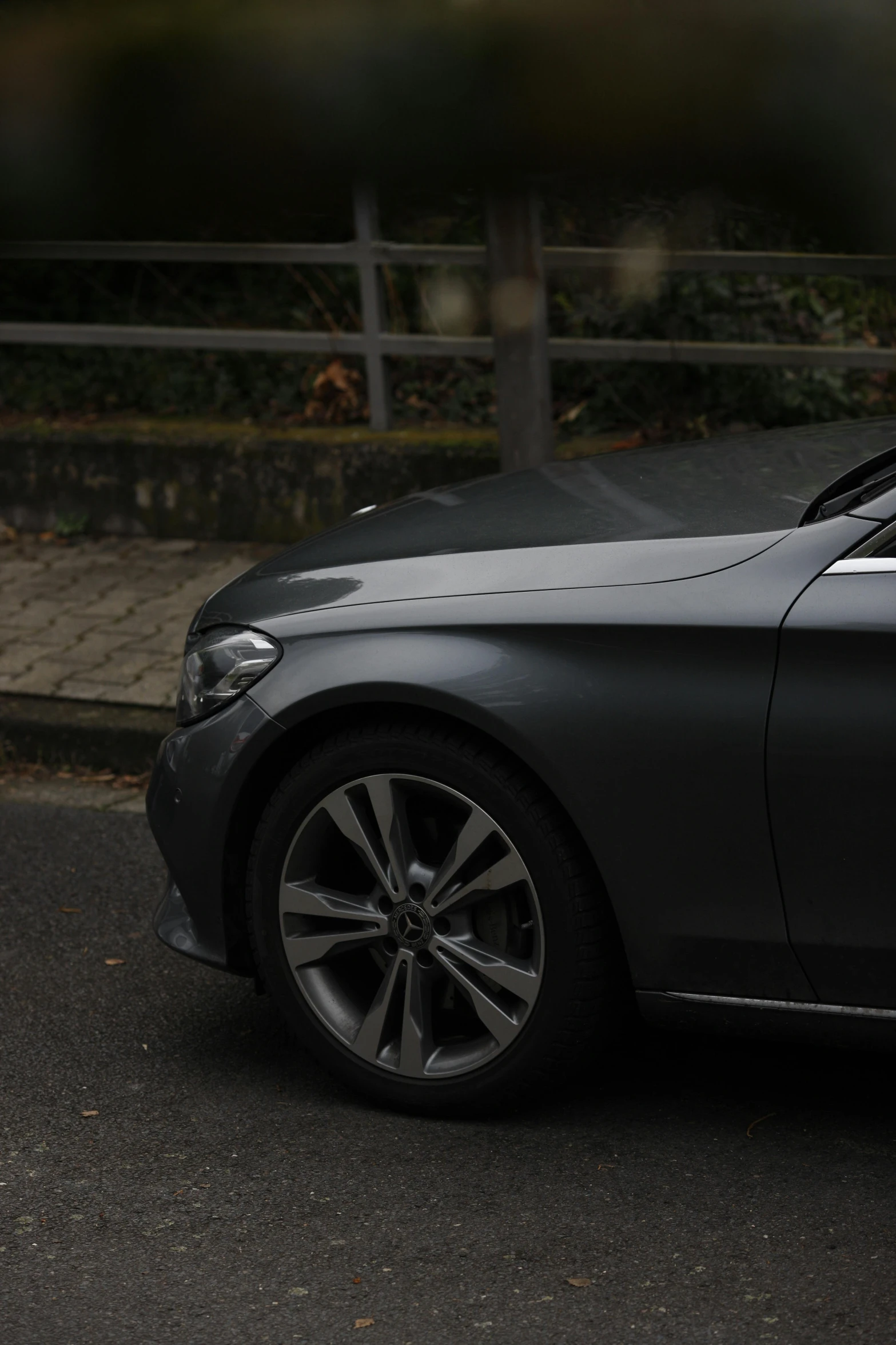 a black mercedes car parked outside the gates