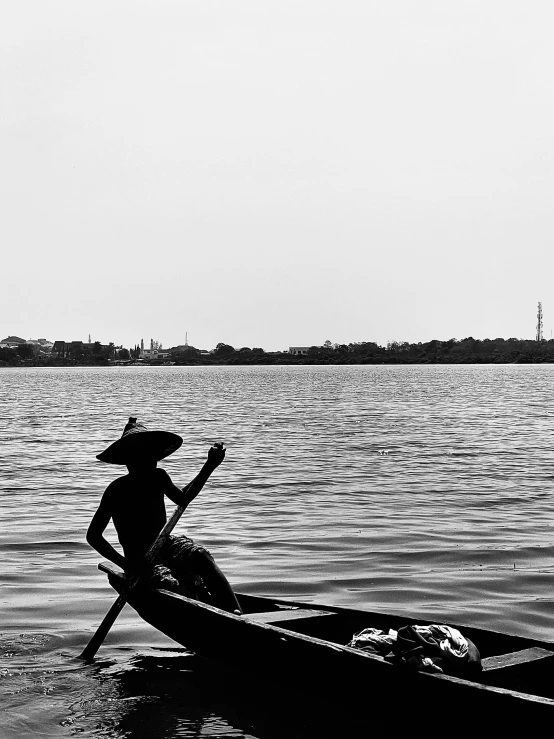 a black and white photo of a person in a boat, by Sudip Roy, cinematic. by leng jun, thawan duchanee, famous photo, siluette