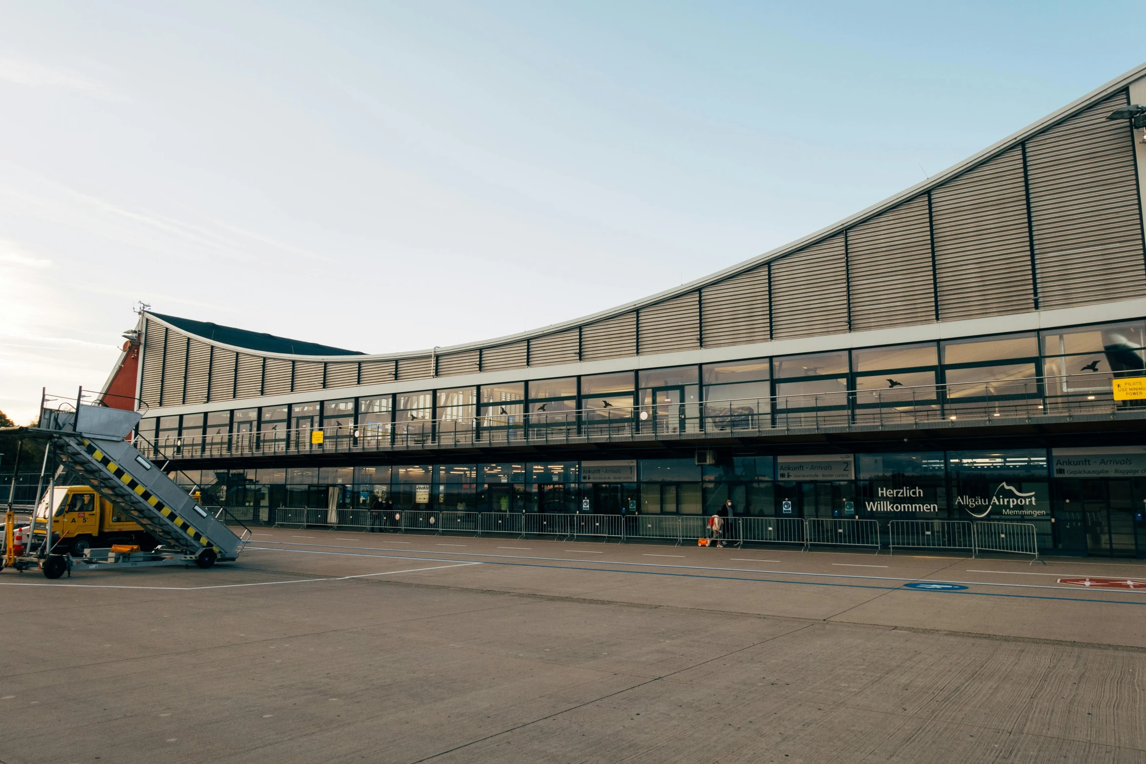 a large passenger jet sitting on top of an airport tarmac, unsplash, bauhaus, sportspalast amphitheatre, seen from outside, aardman studios, mies van der rohe