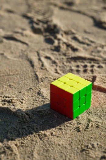the small, square, colored block is on a beach